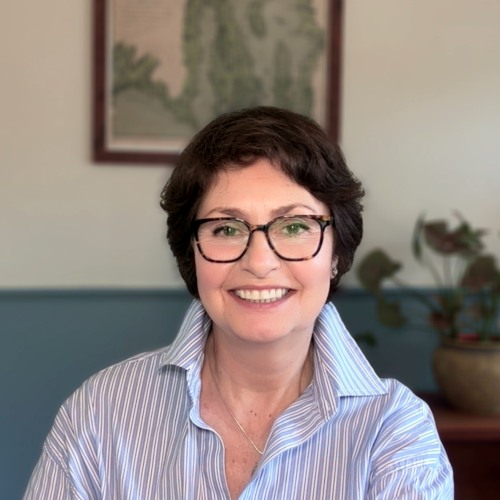 head and shoulders portrait of smiling adult with glasses, Maria Sokolova